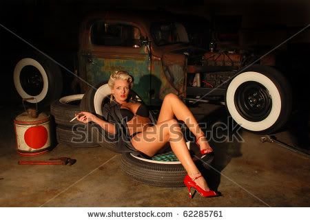 stock-photo-pin-up-girl-in-garage-with-a-classic-truck-62285761.jpg